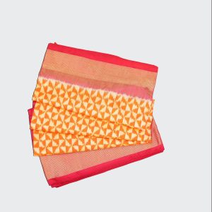 Red and saffron yellow Pochampally pattu saree with bold ikat motifs on glossy silk fabric showcasing contrasting panels and intricate handwoven texture
